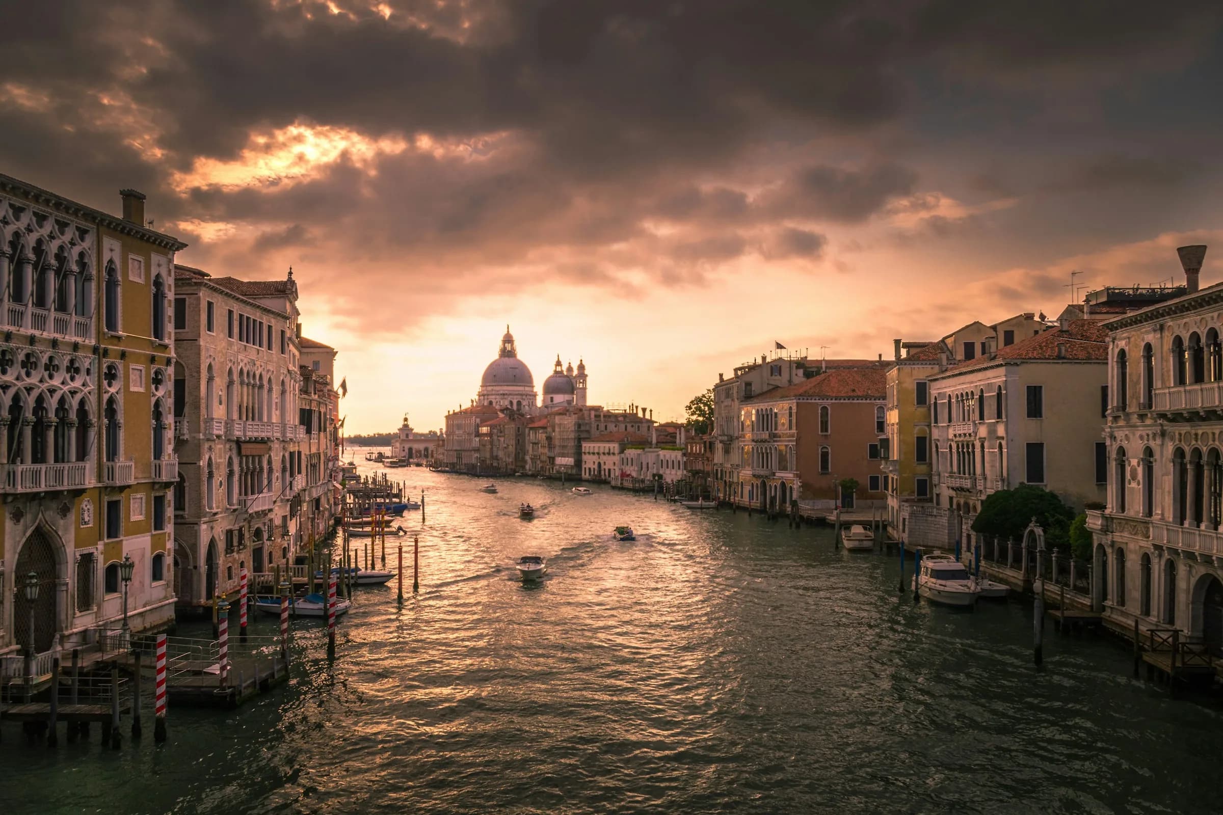 Venice Grand Canal historic palazzos and basilica under warm evening twilight sky